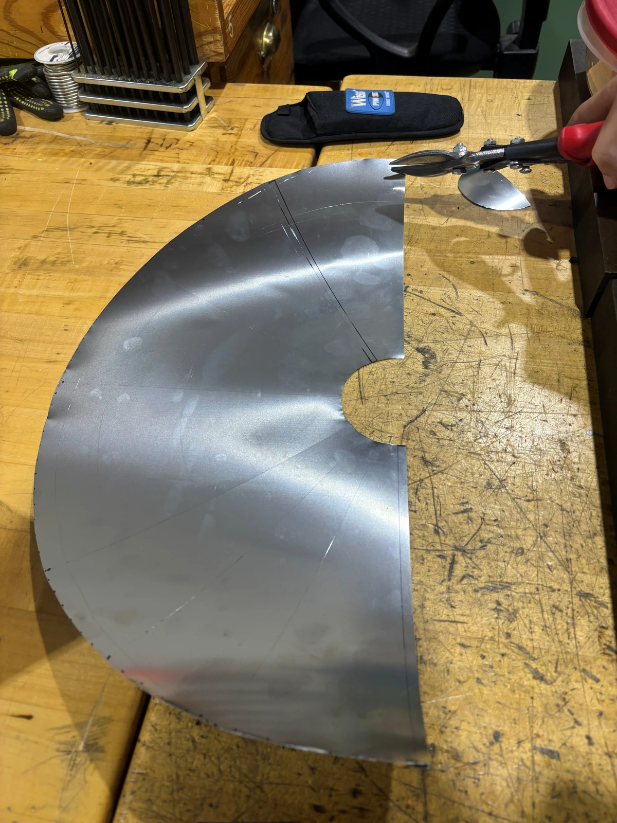 Cutting the metal wrap for a cone iteration.