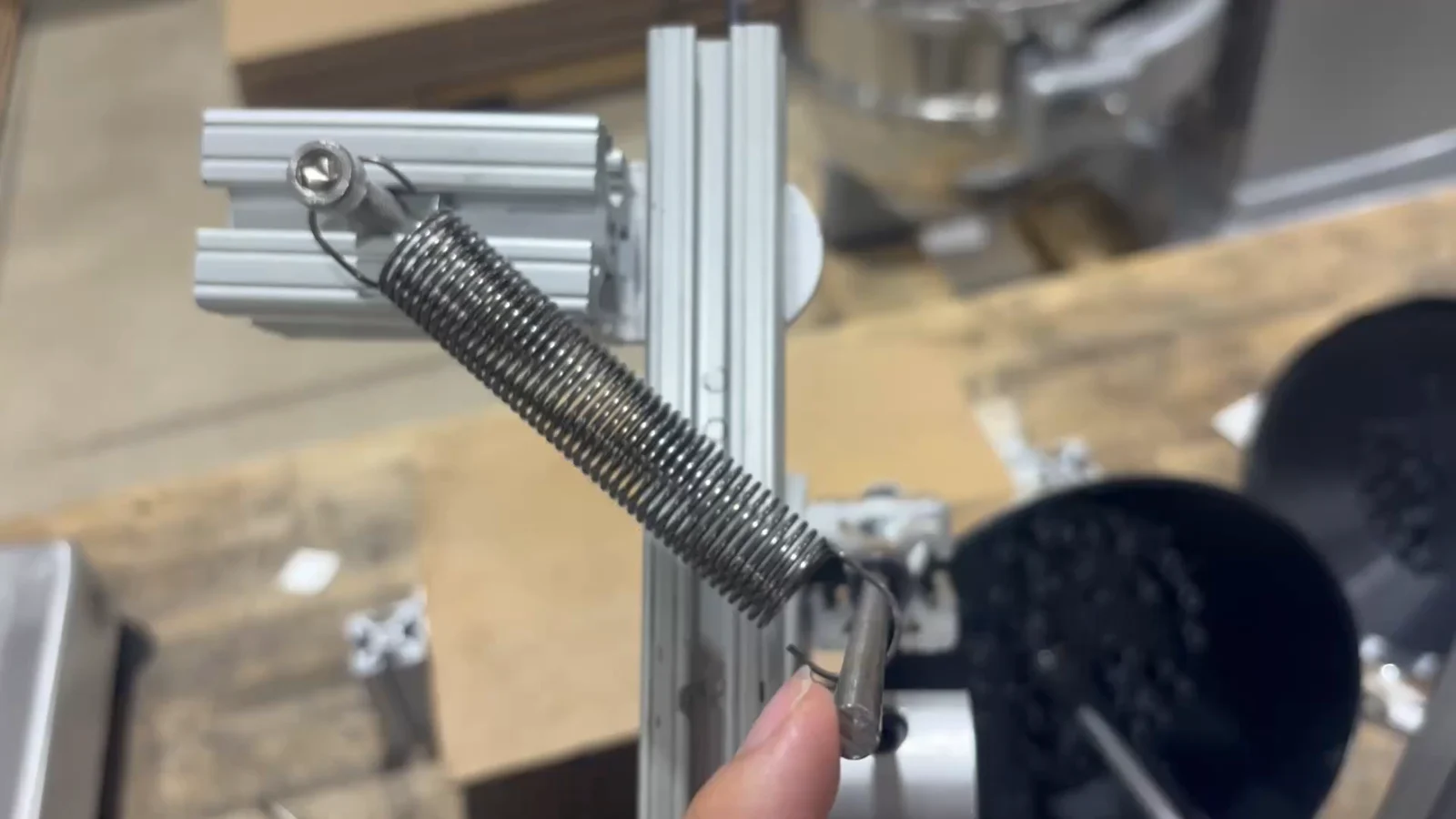 Spring-loaded roller test rig.