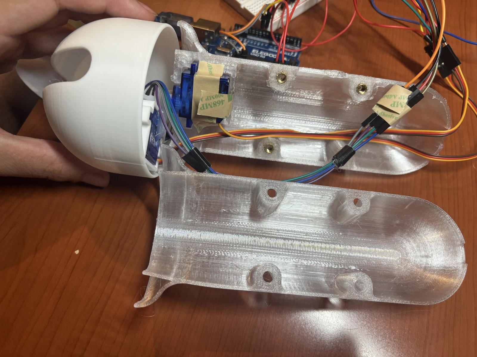 Prototype stabilizing spoon with its two-axis mechanism exposed
